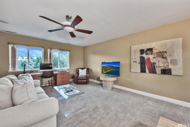 living room with ceiling fan and carpet floors