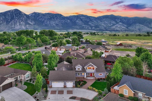 aerial view at dusk featuring a mountain view