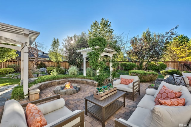 view of patio with an outdoor living space with a fire pit