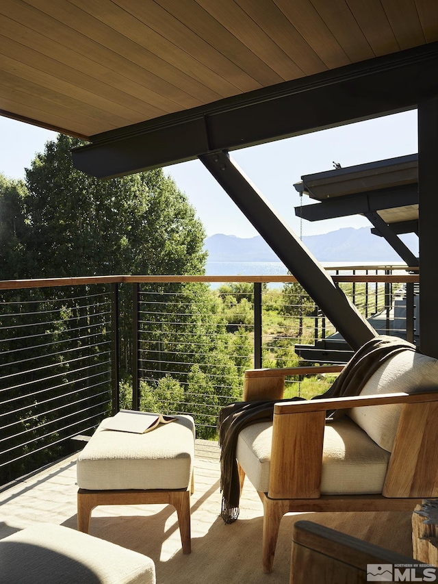 view of patio featuring a balcony and a mountain view