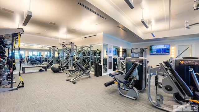 gym with ornamental molding and carpet flooring