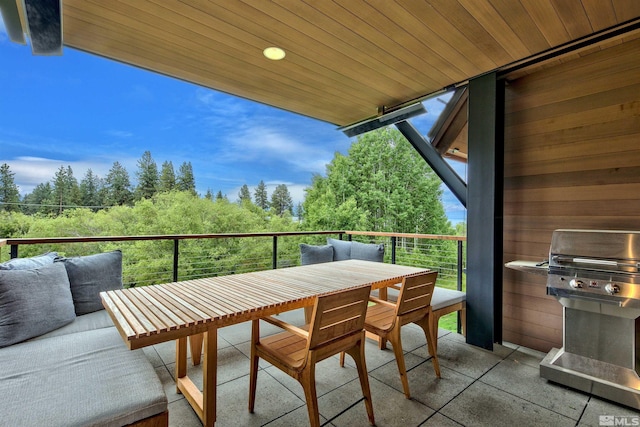 balcony with area for grilling and an outdoor hangout area