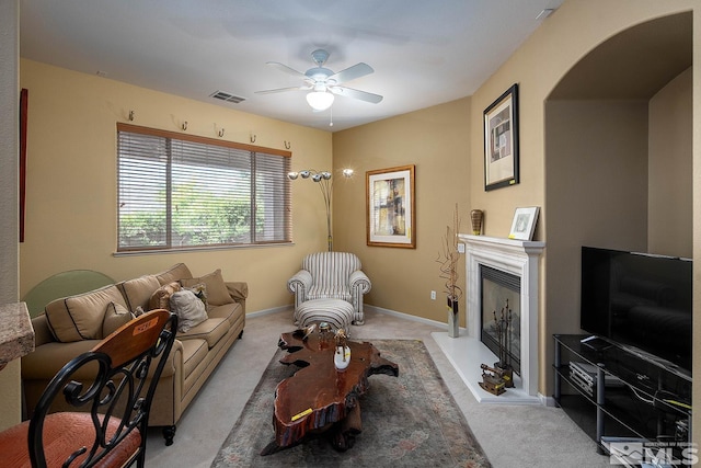 living room with ceiling fan and light colored carpet