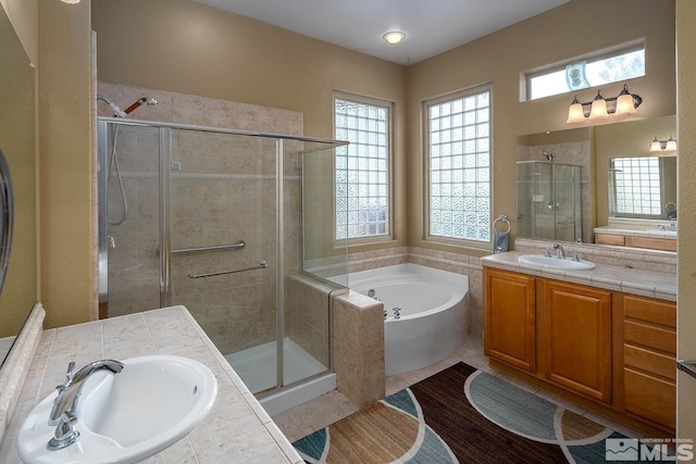 bathroom featuring tile patterned floors, vanity, and independent shower and bath