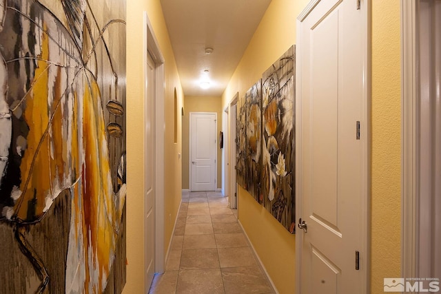 corridor with light tile patterned floors