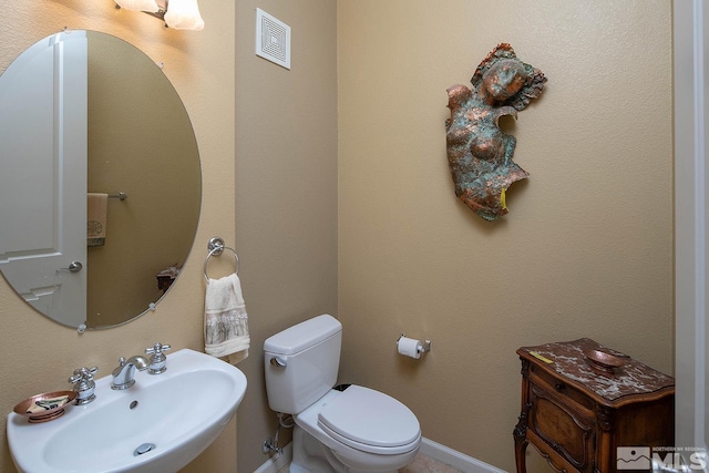 bathroom with toilet and sink