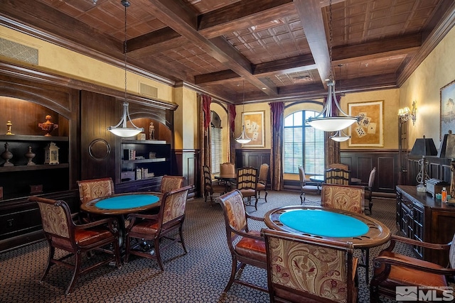 recreation room with beam ceiling, coffered ceiling, dark carpet, wood ceiling, and ornamental molding