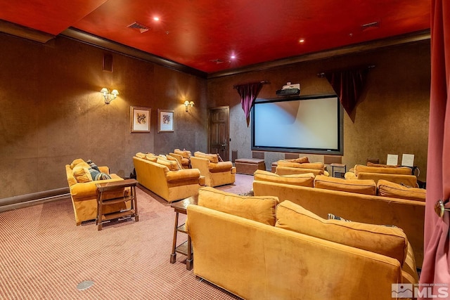 cinema room with carpet and crown molding