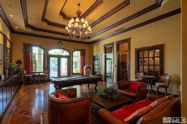 playroom featuring dark parquet flooring, french doors, a tray ceiling, crown molding, and an inviting chandelier