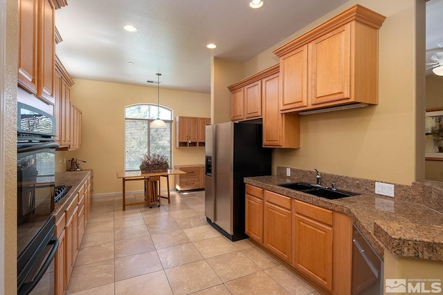 kitchen featuring light tile patterned flooring, sink, hanging light fixtures, and stainless steel appliances