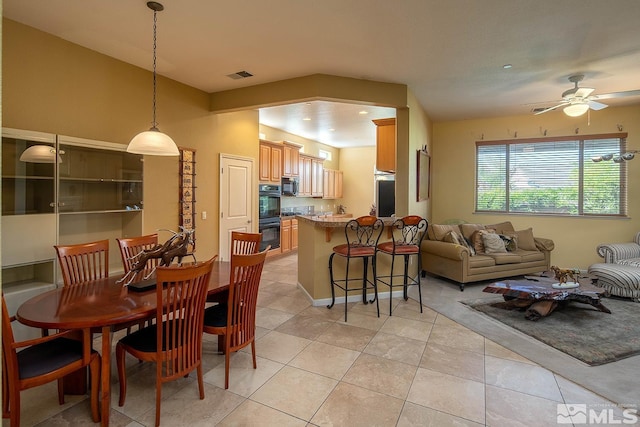 dining area with ceiling fan and light tile patterned floors