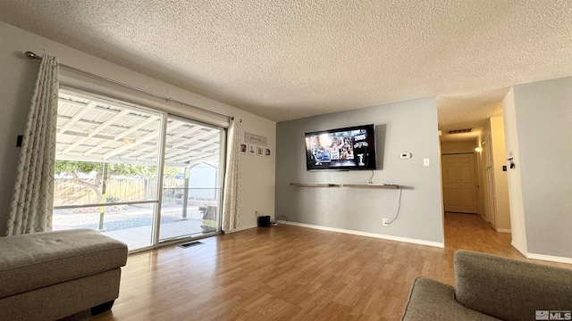 living room featuring hardwood / wood-style floors and a textured ceiling