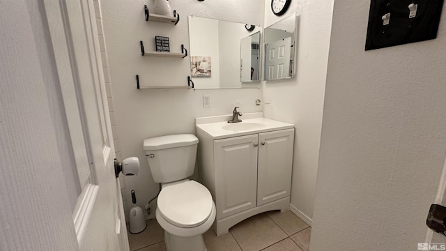 bathroom with tile patterned floors, vanity, and toilet