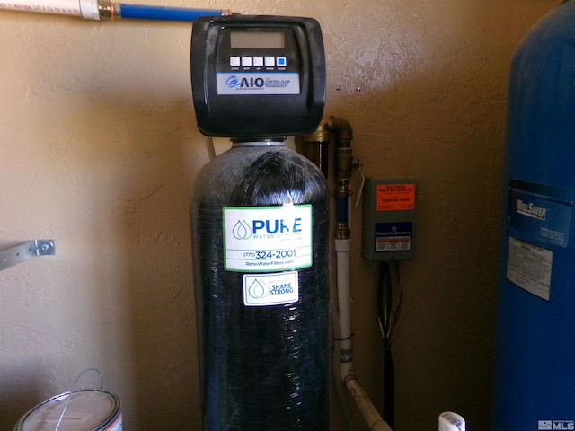 utility room featuring water heater