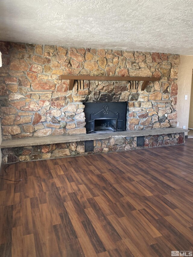 interior details featuring a textured ceiling and wood-type flooring