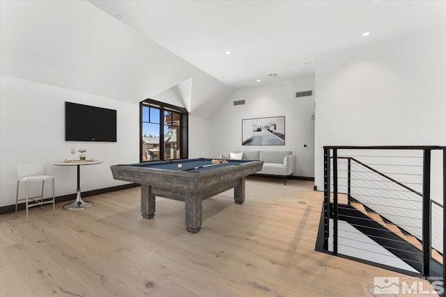 rec room featuring light hardwood / wood-style floors, lofted ceiling, and pool table