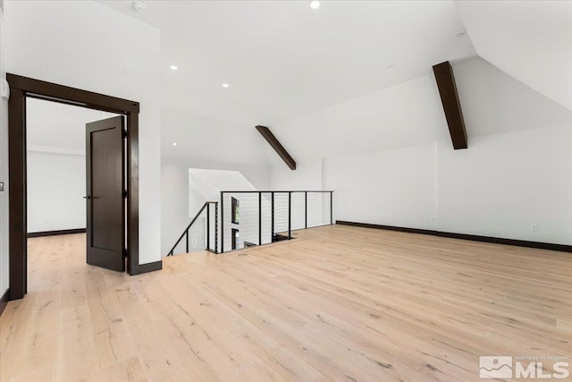 bonus room featuring vaulted ceiling with beams and light hardwood / wood-style floors