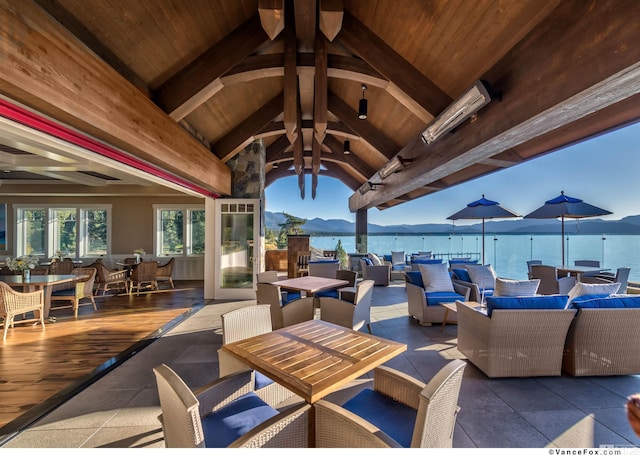 view of patio / terrace featuring a water and mountain view and an outdoor hangout area