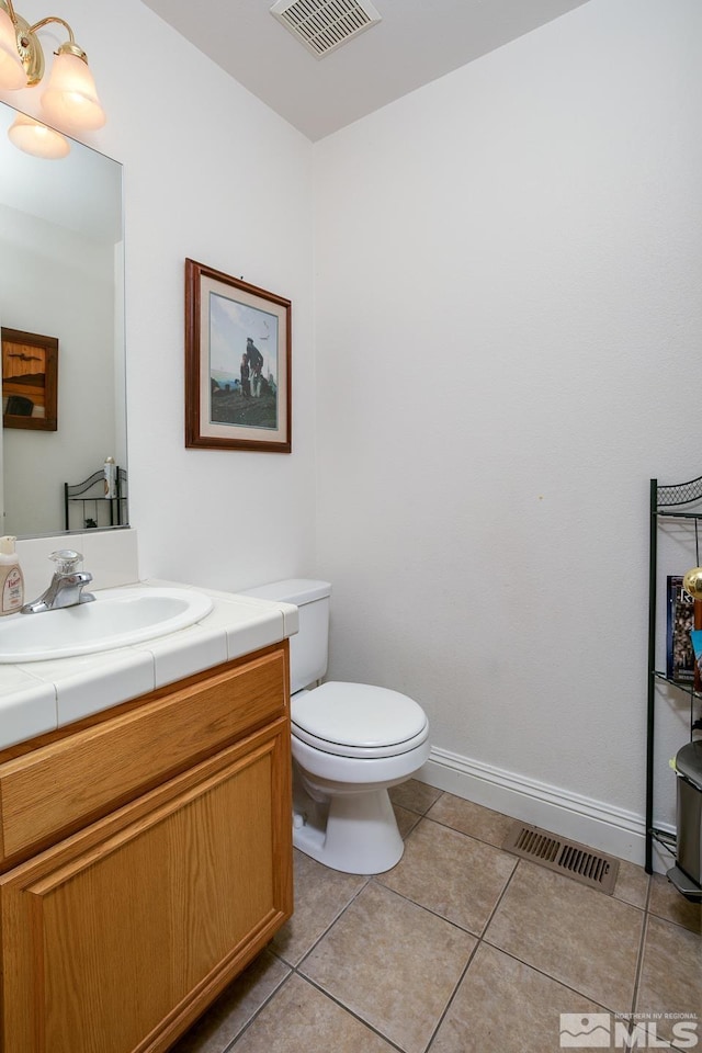 bathroom with tile patterned floors, vanity, and toilet