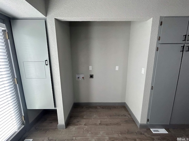 clothes washing area with dark hardwood / wood-style floors, washer hookup, and hookup for an electric dryer