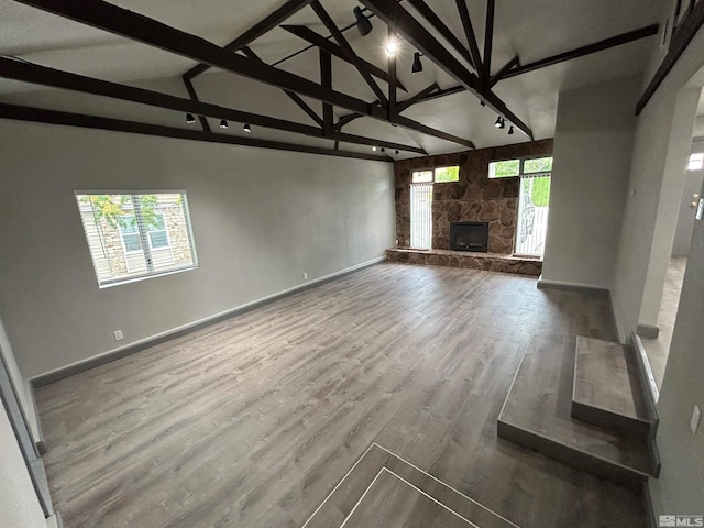 unfurnished living room featuring a wealth of natural light, hardwood / wood-style floors, and a fireplace