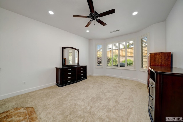 interior space with light carpet and ceiling fan