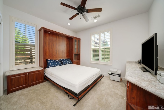 bedroom featuring ceiling fan and light carpet