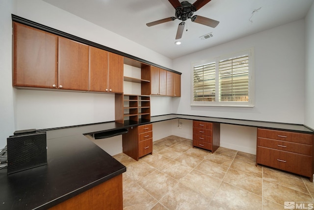 office with built in desk and ceiling fan