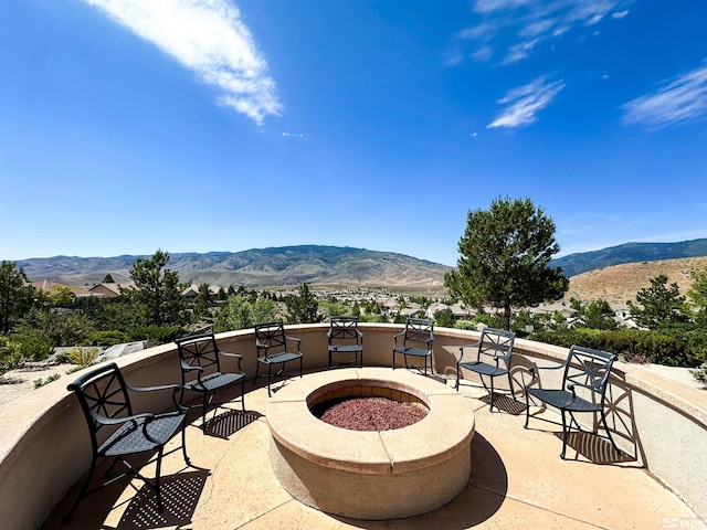 view of patio featuring a mountain view and an outdoor fire pit