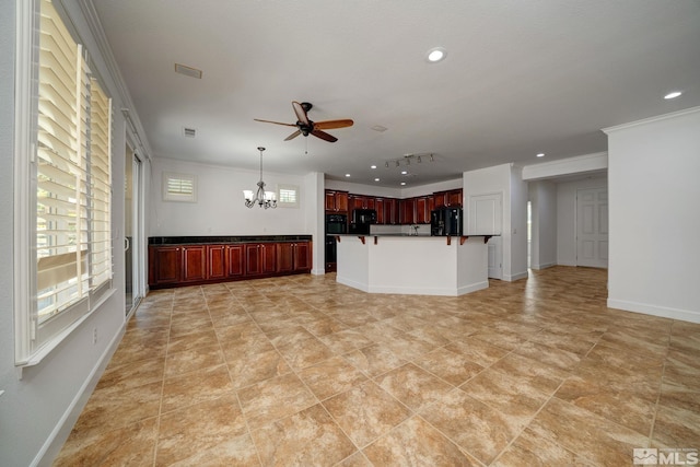 kitchen featuring oven, pendant lighting, fridge, ceiling fan with notable chandelier, and ornamental molding