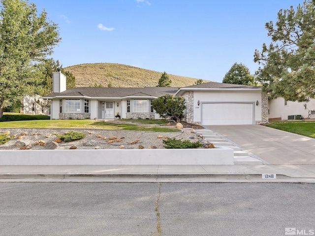 view of front of house featuring central AC and a garage