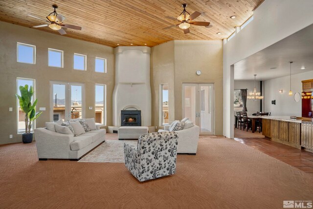 living room with tile flooring, a towering ceiling, and wood ceiling