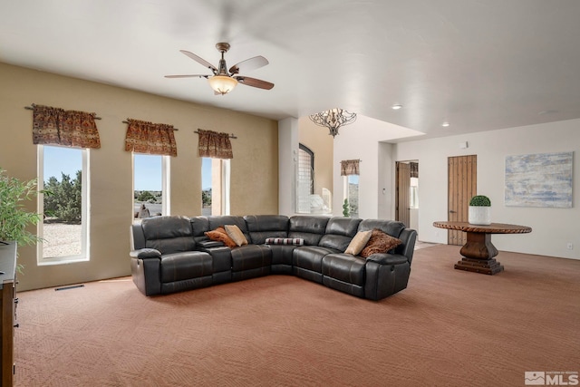 carpeted living room featuring ceiling fan