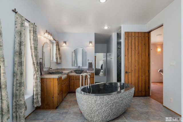 bathroom featuring tile flooring, dual vanity, and a bathing tub