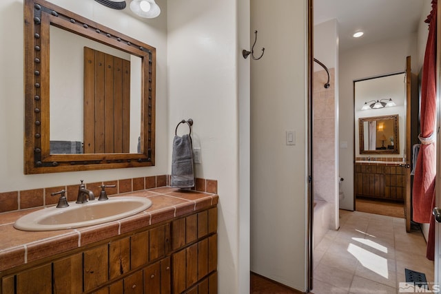 bathroom featuring vanity, shower / bathing tub combination, and tile floors