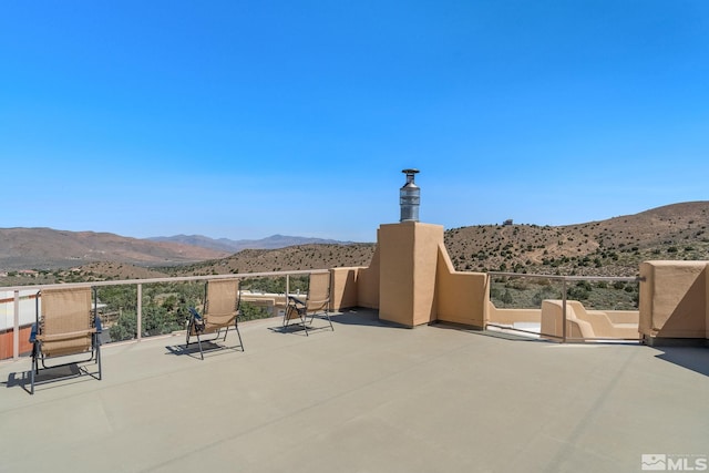 view of terrace featuring a mountain view and a balcony