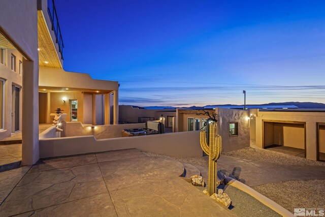 view of patio terrace at dusk