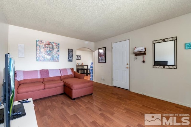 living room with hardwood / wood-style floors and a textured ceiling