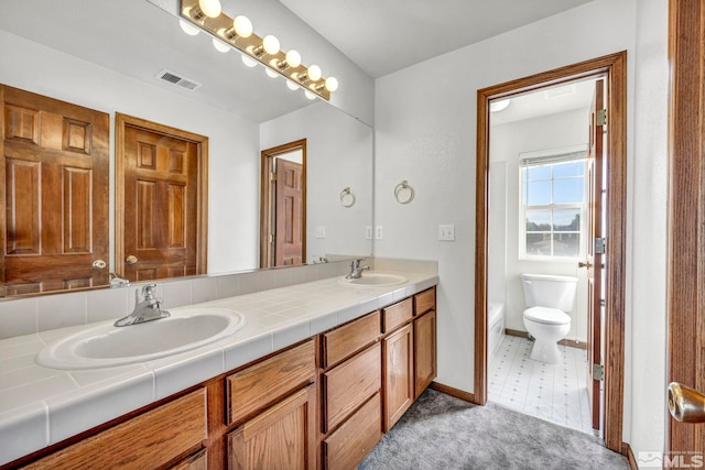 bathroom with tile patterned floors, vanity, and toilet