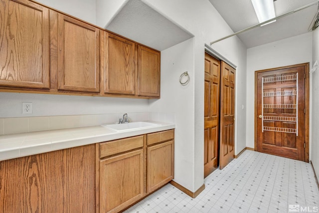 kitchen with tile countertops and sink