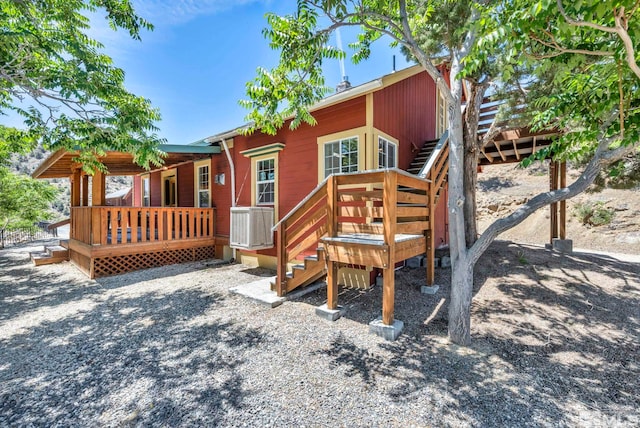 rear view of house featuring a deck