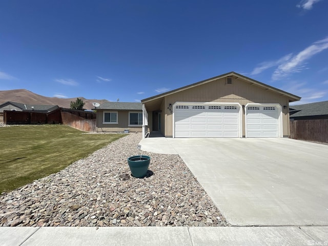 ranch-style house featuring a front yard and a garage