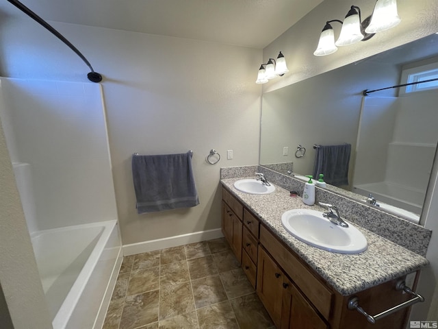 bathroom featuring vanity and  shower combination