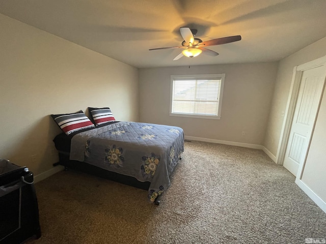 bedroom featuring dark carpet and ceiling fan