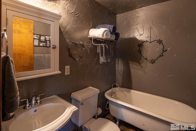 bathroom with sink, toilet, and a tub