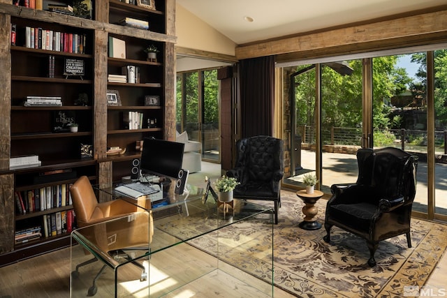 sitting room with wood-type flooring and vaulted ceiling