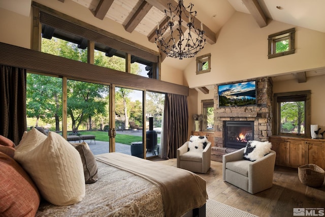 bedroom with beamed ceiling, an inviting chandelier, access to exterior, high vaulted ceiling, and light hardwood / wood-style flooring