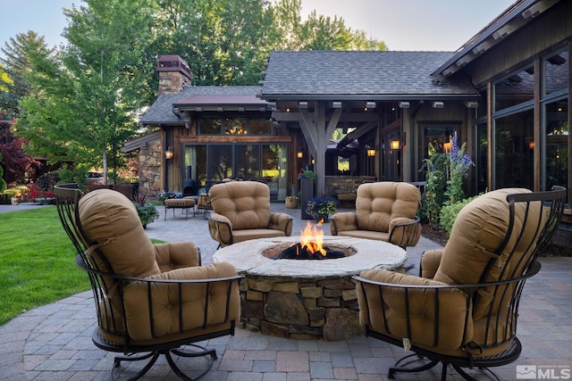 view of patio / terrace with an outdoor living space with a fire pit