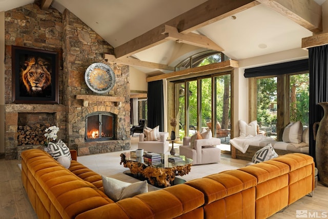 living room with vaulted ceiling with beams, a fireplace, and hardwood / wood-style flooring