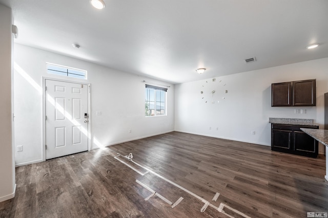 unfurnished living room with dark hardwood / wood-style flooring